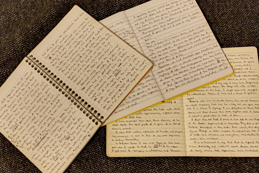 Three notebooks filled with the handwritten draft of a memoir about Denys Fisher