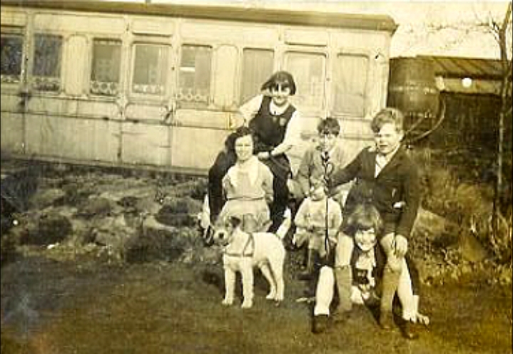Denys Fisher as a boy with his mother and four siblings outside their railway carriage home in the 1920's
