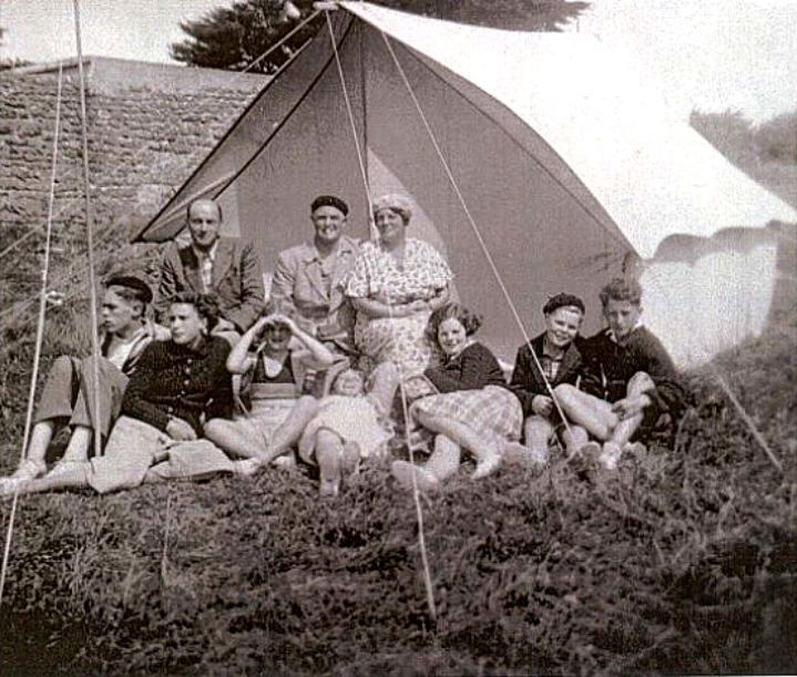 Denys Fisher sat with his family and friends outside a large tent in France
