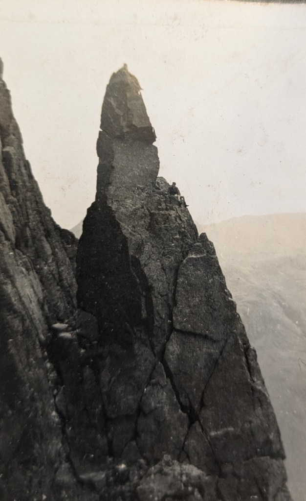 Denys Fisher sat on a ledge halfway up the Napes Needle pinnacle in the Lake District.